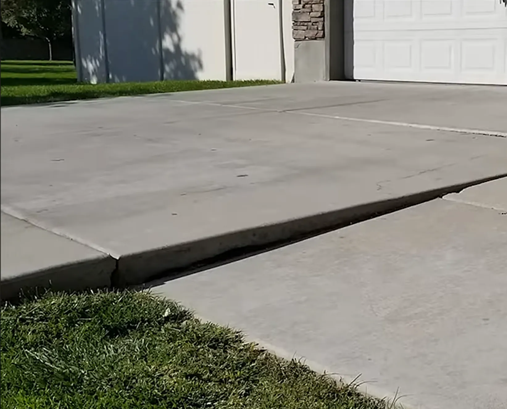 Before driveway repair - sunken concrete panel