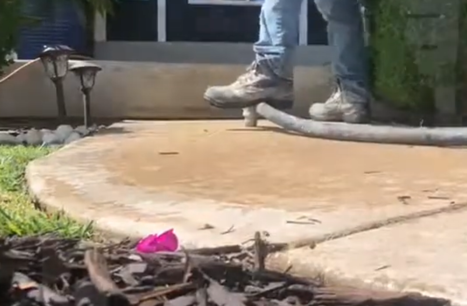 Mudjacking process - slurry being pumped through a hole to lift a sunken concrete slab