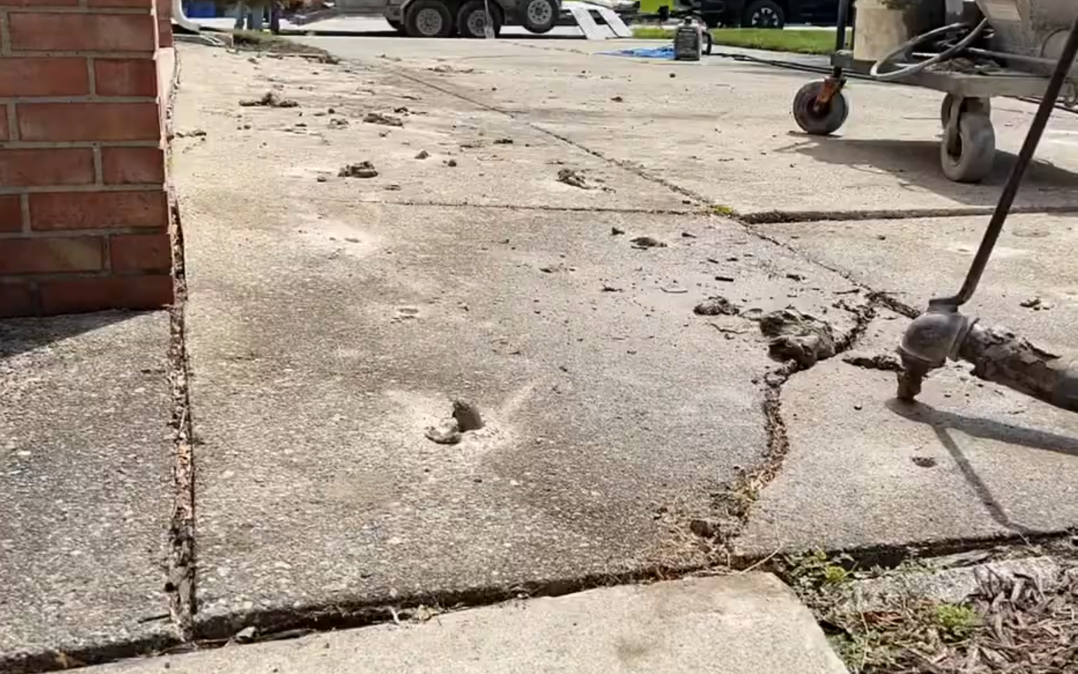 Mudjacking service lifting a sunken concrete slab